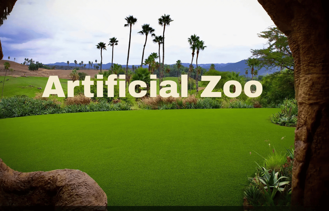 Artificial Zoo landscape with lush green grass and palms.