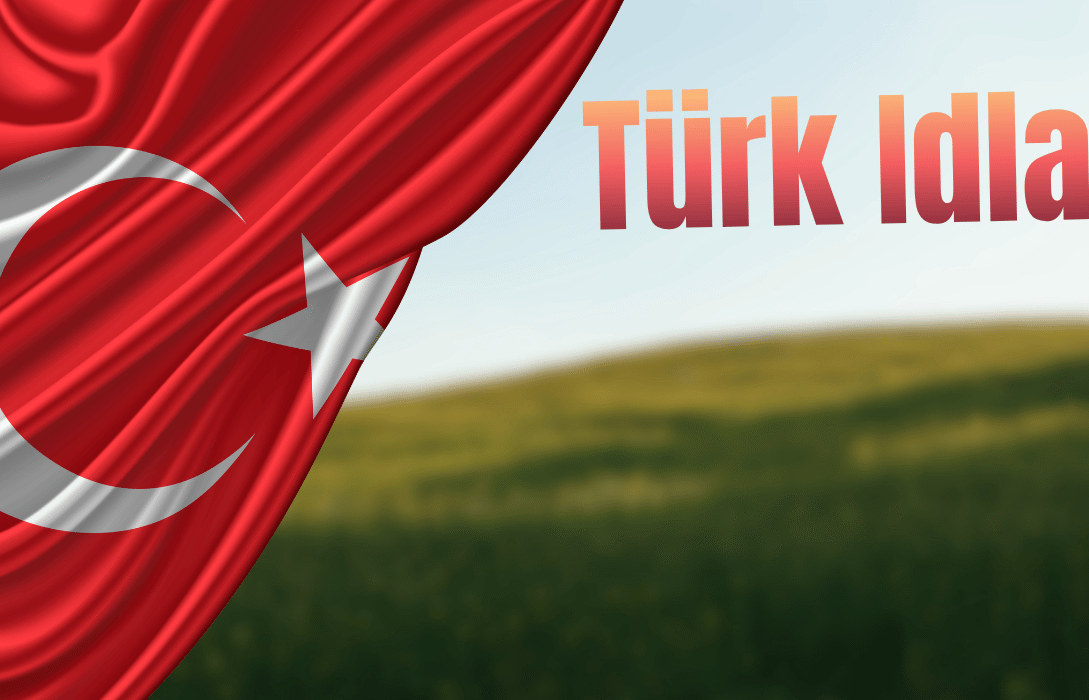 Turkish flag draped over a blurred green field landscape with the text "Türk Idla."