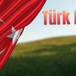 Turkish flag draped over a blurred green field landscape with the text "Türk Idla."