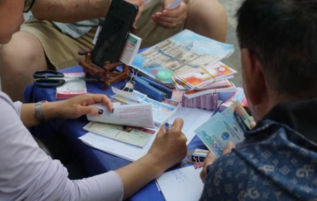 People buying and checking Premier Lotteries tickets