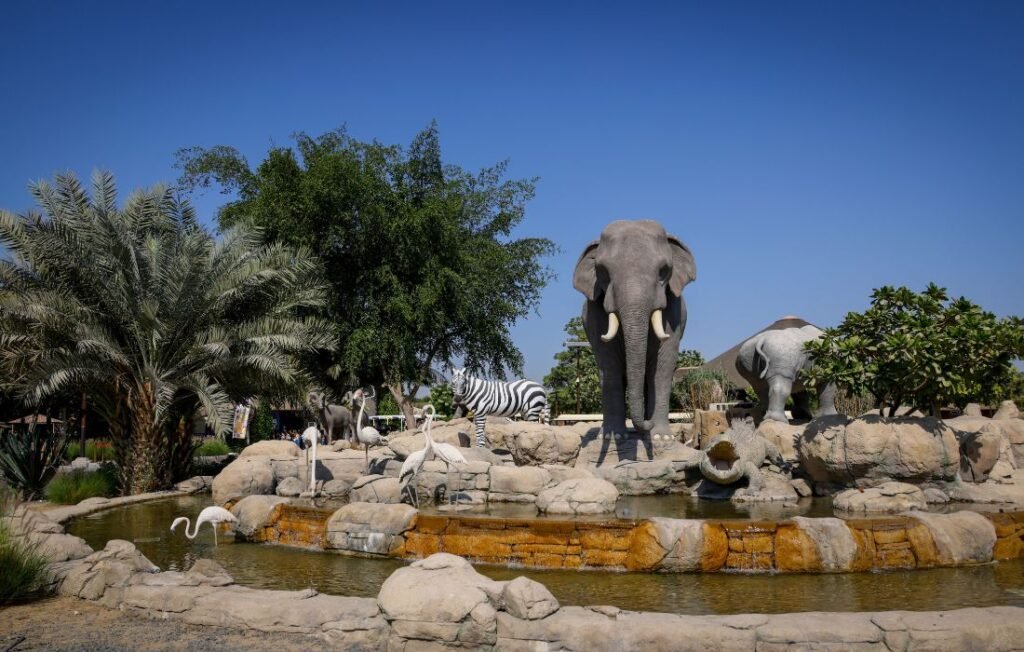 Artificial Zoo display with elephants, zebras, flamingos, and a water pond